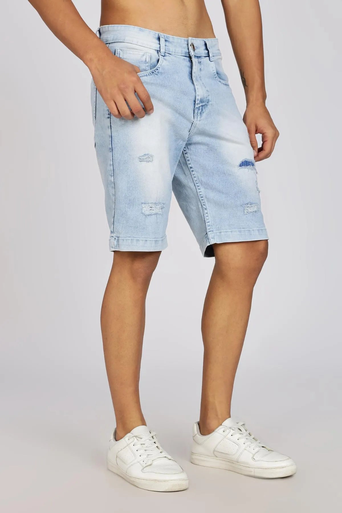 Light blue denim shorts worn by a person on a plain background