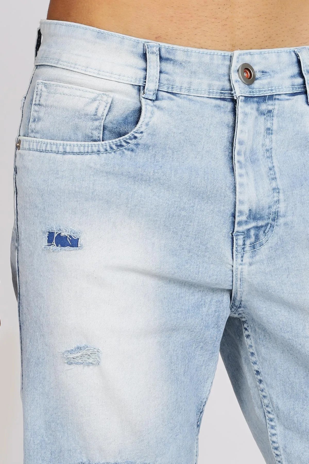 Light blue distressed jeans on a plain background