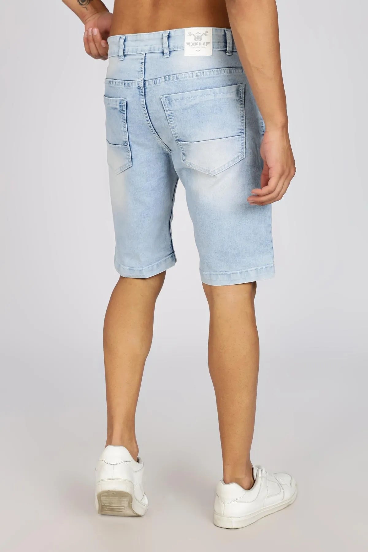 Light blue denim shorts worn by a person on a plain background